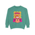A holiday sweatshirt featuring a cute ghost character wearing a Santa hat, with two smaller ghosts on either side. Above them is the playful text "Boo Humbug," surrounded by snowflakes and festive elements. The design humorously combines spooky and festive themes for a unique holiday look.